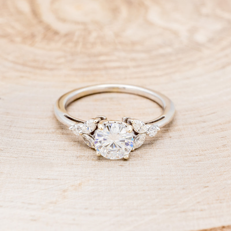 "BLOSSOM" - ROUND CUT MOISSANITE ENGAGEMENT RING WITH LEAF-SHAPED DIAMOND ACCENTS