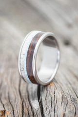 Shown here is "Rainier", a custom, handcrafted men's wedding ring featuring ironwood, antler, and turquoise inlays, shown here on a titanium band. Additional inlay options are available upon request.