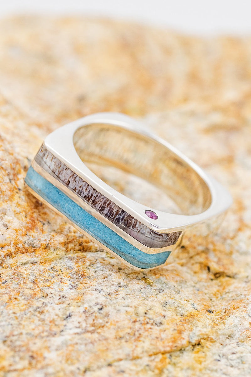 Shown here is  "Mesa", a custom, handcrafted wedding ring featuring a custom shaped and cast silver band with turquoise and elk antler inlays with two offset rubies.  Additional inlay options are available upon request.