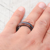 Shown here, Remmy, is a custom, handcrafted men's wedding ring featuring a redwood overlay and an offset turquoise inlay, shown here on a fire-treated black zirconium band. Additional inlay options are available upon request.