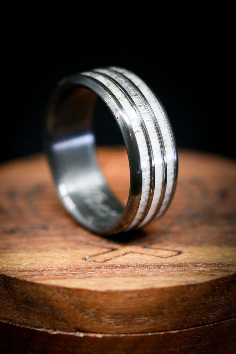Shown here is "Rio", a custom, handcrafted men's wedding ring featuring 3 elk antler inlays, shown here on a fire-treated black zirconium band. Additional inlay options are available upon request.-Antler Wedding Band - Black & White Wedding Ring - Staghead Designs