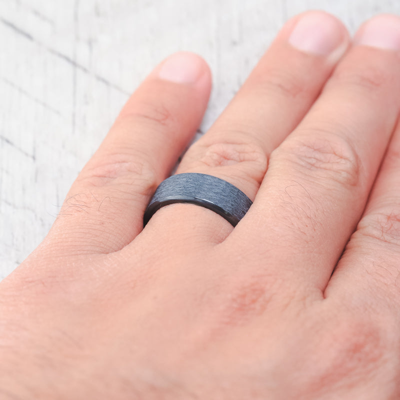 Shown here, a matching wedding band set featuring two black zirconium bands with a hammered finish.