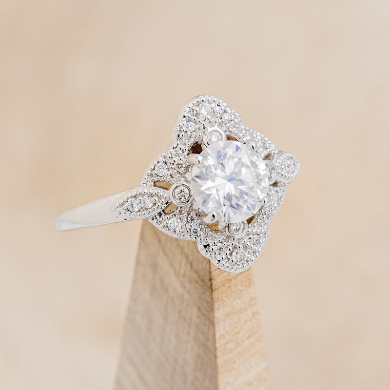 "FLORENCE" - ROUND CUT MOISSANITE ENGAGEMENT RING WITH DIAMOND ACCENTS