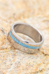 Shown here is "Vertigo", a custom, handcrafted men's wedding ring featuring a turquoise inlay, shown here on a titanium band. Additional inlay options are available upon request.