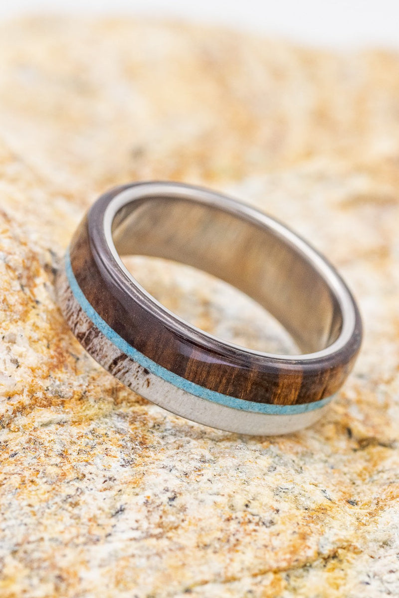 Shown here is "Banner", a custom, handcrafted men's wedding ring featuring a turquoise,  ironwood, and naturally shed antler, shown here on a titanium band. Additional inlay options are available upon request.