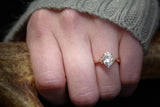 Shown on a Woman's Hand is the ZELLA,  a Custom Oval Moissante Engagement Ring With Diamond Accents
