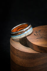 Shown here is "Element", a custom, handcrafted men's wood-lined wedding ring featuring patina copper, elk antler, and hand-crushed turquoise, shown here on a titanium band. Additional inlay options are available upon request.