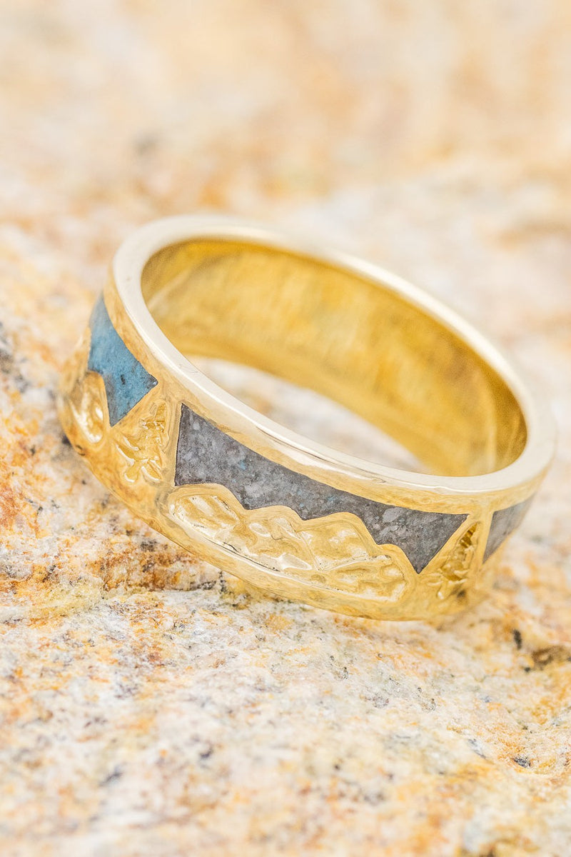 Shown here is  "Summit", a custom, handcrafted men's wedding ring featuring a mountain range engraved into a 14k gold band with turquoise and larimar inlays.  Additional inlay options are available upon request.