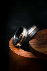 Shown here is Matching wedding band set featuring two rings with a rose gold inlay shown here on hammered black zirconium rings.-Matching Black and Gold Wedding Rings - Hammered Black Zirconium Rings - Staghead Designs