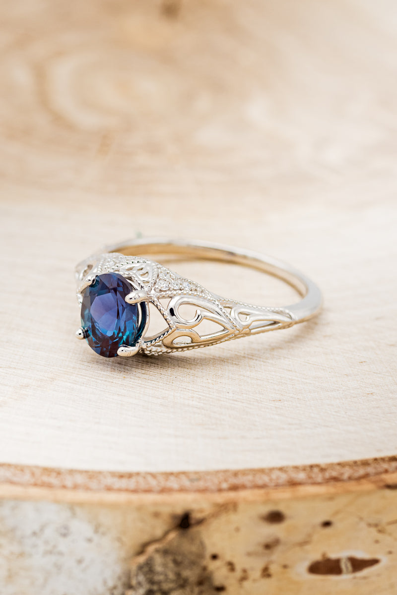 Shown here is"Relica", a vintage-style lab-created Alexandrite women's engagement ring with diamond accents, facing left. Many other center stone options available upon request.