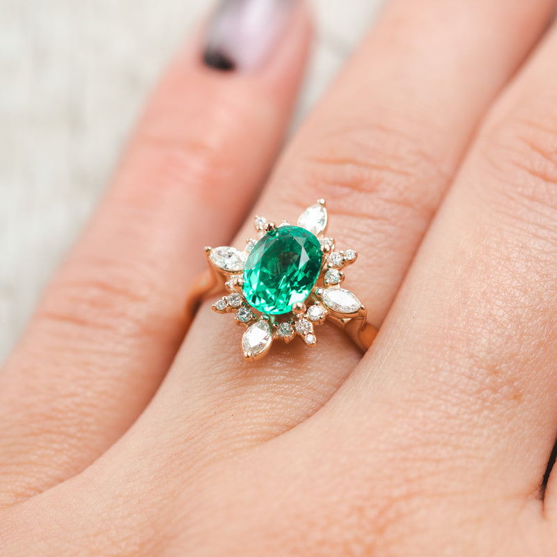 Show here is Azalea, a lab-created emerald women's engagement ring with a diamond halo, On hand, Many other center stone options are available upon request. 