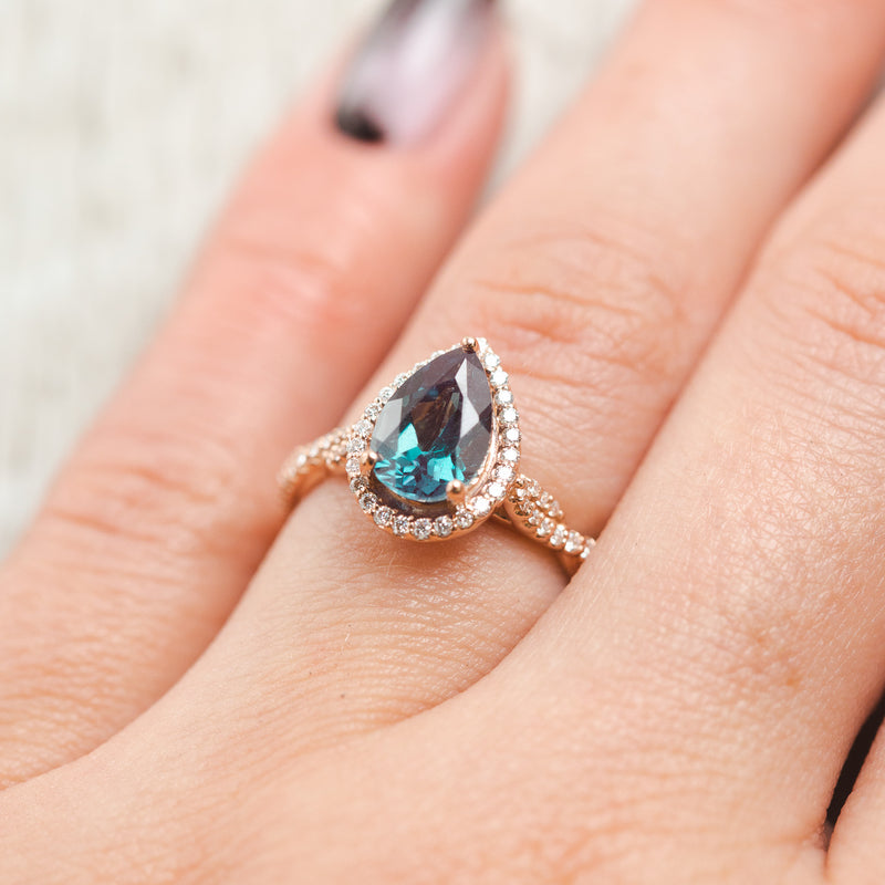 Shown here, Kinley, a lab-created alexandrite women's engagement ring with a diamond halo and diamond accents, on hand. Many other center stone options are available upon request.  