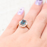 Shown here, Ophelia, a lab-created alexandrite women's engagement ring with a diamond halo and diamond accents, on hand. Many other center stone options are available upon request.