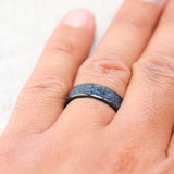 Shown here, Rainier, a custom, handcrafted men's wedding ring featuring a lapis lazuli inlay, on hand. Additional inlay options are available upon request.