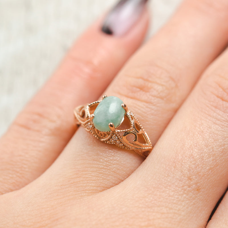 Shown here, Relica, a vintage-style jade women's engagement ring with diamond accents, on hand. Many other center stone options are available upon request. 