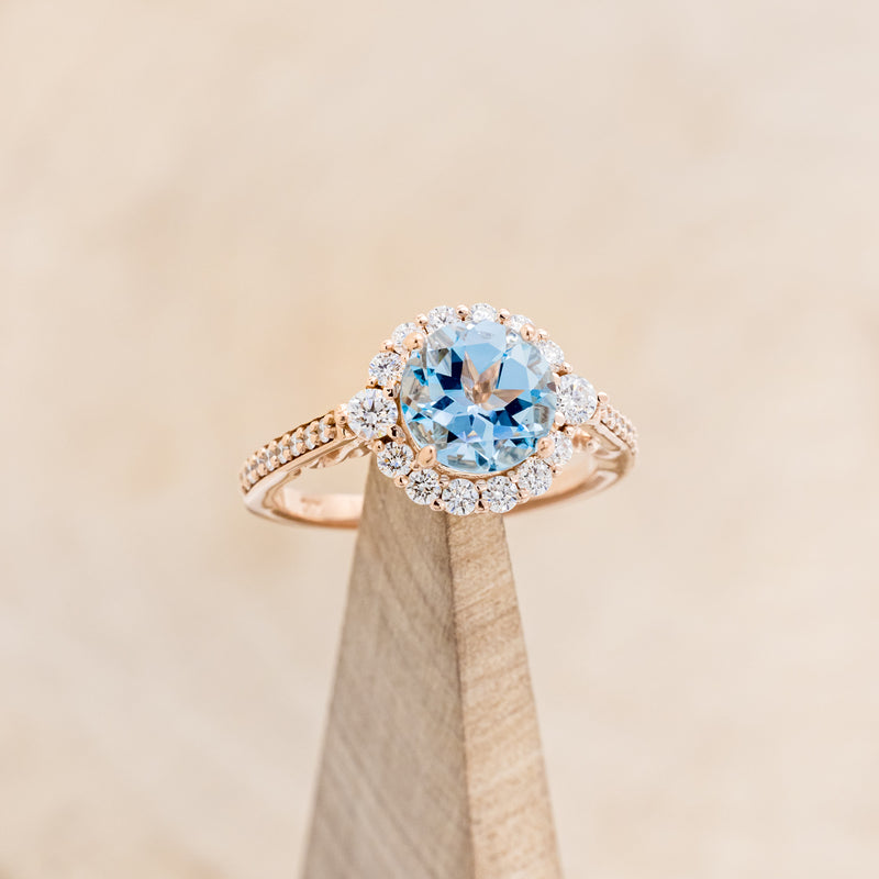 "OPHELIA" - ROUND CUT SKY BLUE TOPAZ ENGAGEMENT RING WITH DIAMOND HALO & ACCENTS