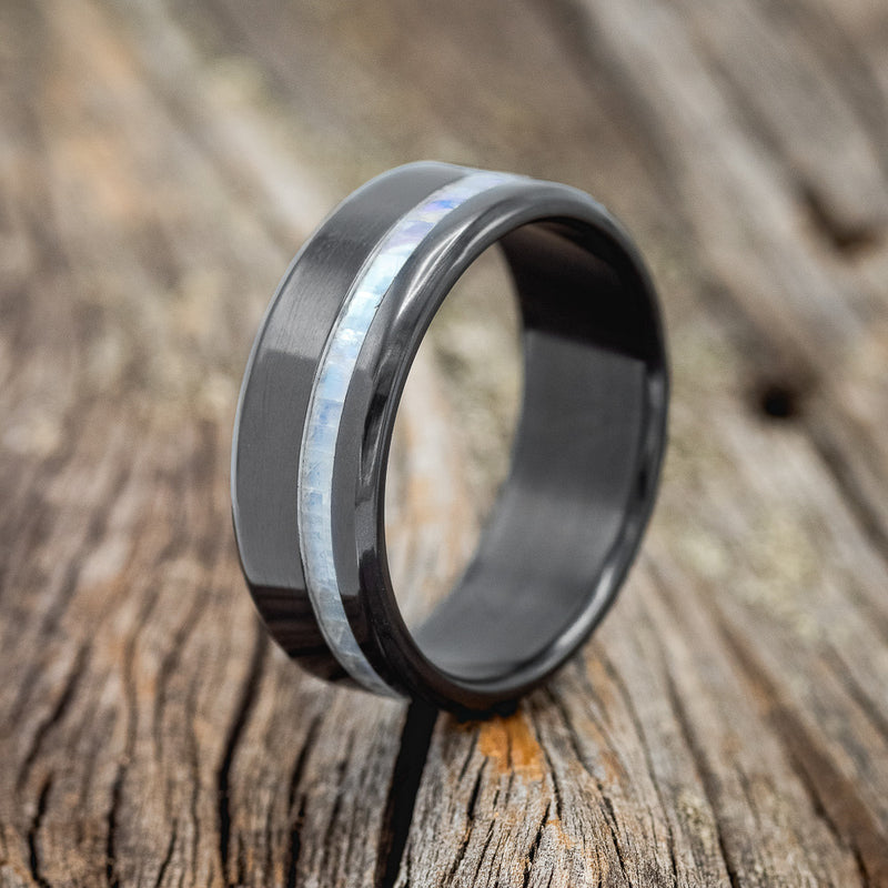 Shown here is "Vertigo", a handcrafted men's wedding ring featuring a mother of pearl inlay, upright facing left.