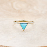 Shown here is "Jenny From The Block", a dainty-style triangle turquoise women's engagement ring, front facing. Many other center stone options are available upon request.