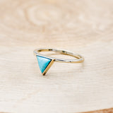Shown here is "Jenny From The Block", a dainty-style triangle turquoise women's engagement ring, facing left. Many other center stone options are available upon request.