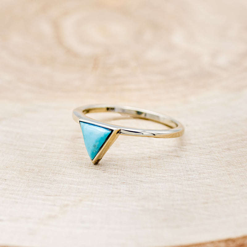 Shown here is "Jenny From The Block", a dainty-style triangle turquoise women's engagement ring, facing left. Many other center stone options are available upon request.