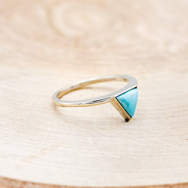 Shown here is "Jenny From The Block", a dainty-style triangle turquoise women's engagement ring, facing right. Many other center stone options are available upon request.