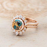 Shown here is "Esmeralda", a round cut spiny oyster turquoise women's engagement ring with diamond accents and a diamond tracer, facing left. Many other center stone options are available upon request.