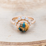 Shown here is "Esmeralda", a round cut spiny oyster turquoise women's engagement ring with diamond accents, front facing. Many other center stone options are available upon request.