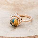 Shown here is "Esmeralda", a round cut spiny oyster turquoise women's engagement ring with diamond accents, facing left. Many other center stone options are available upon request.