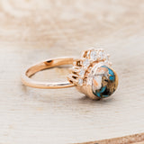 Shown here is "Esmeralda", a round cut spiny oyster turquoise women's engagement ring with diamond accents, facing right. Many other center stone options are available upon request.