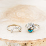 Shown here is "Esmeralda", a round cut spiny oyster turquoise women's engagement ring with diamond accents and a diamond tracer, laying together. Many other center stone options are available upon request.