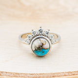 Shown here is "Esmeralda", a round cut spiny oyster turquoise women's engagement ring with diamond accents, front facing. Many other center stone options are available upon request.
