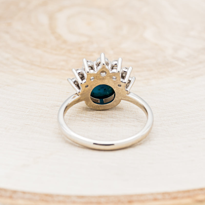 Shown here is "Esmeralda", a round cut spiny oyster turquoise women's engagement ring with diamond accents, back view. Many other center stone options are available upon request.