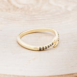Shown here is "Serpent", a snake-style wedding band featuring black diamond accents, facing right.