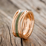 Shown here is men's "Artemis", a custom, handcrafted men's wedding ring featuring a single channel with a moss inlay, upright facing left. Additional inlay options are available upon request.