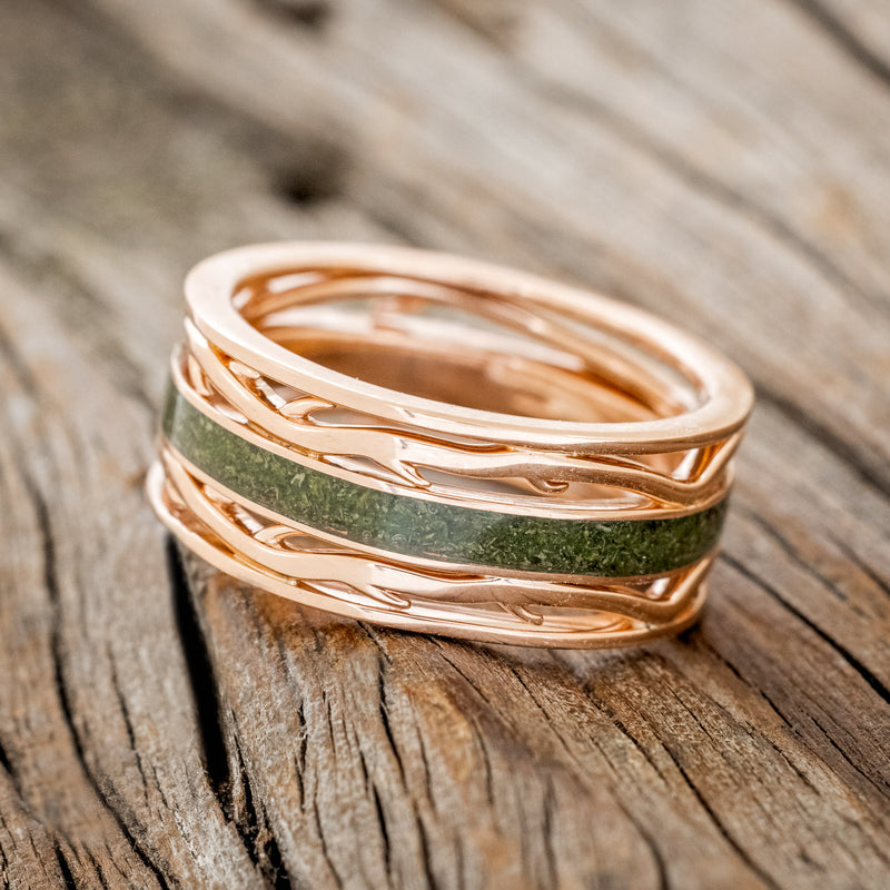 Shown here is men's "Artemis", a custom, handcrafted men's wedding ring featuring a single channel with a moss inlay, tilted left. Additional inlay options are available upon request.