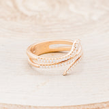 Shown here is "Eve", a snake-style stacking wedding band with diamond accents, facing right.
