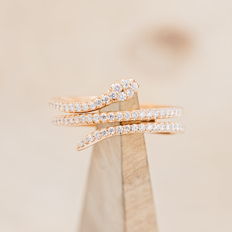 Shown here is "Eve", a snake-style stacking wedding band with diamond accents, on stand front facing.