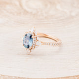 Shown here is The "North Star", a halo-style oval Montana sapphire women's engagement ring, facing left , with delicate and ornate details and is available with many center stone options-Custom Engagement Ring - Vintage Style Engagement Ring - Staghead Designs