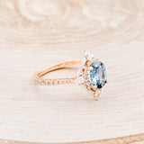 Shown here is The "North Star", a halo-style oval Montana sapphire women's engagement ring, facing right, with delicate and ornate details and is available with many center stone options-Custom Engagement Ring - Vintage Style Engagement Ring - Staghead Designs