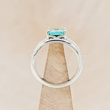 Shown here is "Dolly", a turquoise women's engagement ring with diamond accents, side view on stand. Many other center stone options are available upon request.
