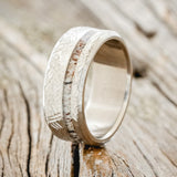 Shown here is "Vertigo", a custom, handcrafted men's wedding ring featuring a naturally shed elk antler inlay with a crosshatched finish, upright facing left. Additional inlay options are available upon request.