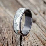Shown here is "Helios", a custom, handcrafted men's wedding ring featuring a mountain range using pieces of silver and crushed fire & ice opal inlay, upright facing left. Additional inlay options are available upon request.