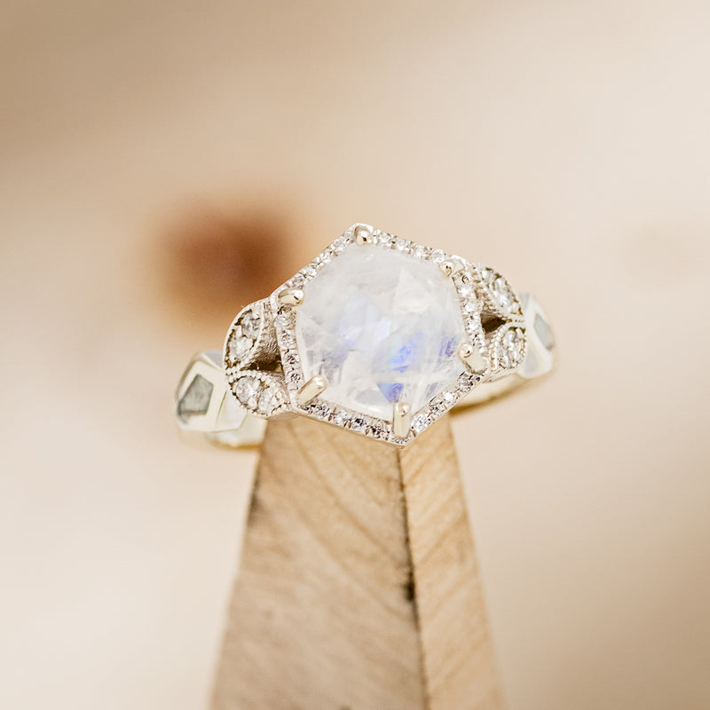 Shown here is The "Lucy in the Sky", a halo-style hexagon faceted moonstone women's engagement ring with delicate and ornate details and is available with many center stone options."LUCY IN THE SKY" FACETED MOONSTONE WEDDING BAND WITH DIAMOND HALO & FIRE AND ICE OPAL INLAYS (choose your own custom inlays!) - Staghead Designs - Antler Rings By Staghead Designs