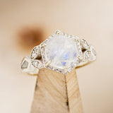 Shown here is The "Lucy in the Sky", a halo-style hexagon faceted moonstone women's engagement ring with delicate and ornate details and is available with many center stone options."LUCY IN THE SKY" FACETED MOONSTONE WEDDING BAND WITH DIAMOND HALO & FIRE AND ICE OPAL INLAYS (choose your own custom inlays!) - Staghead Designs - Antler Rings By Staghead Designs