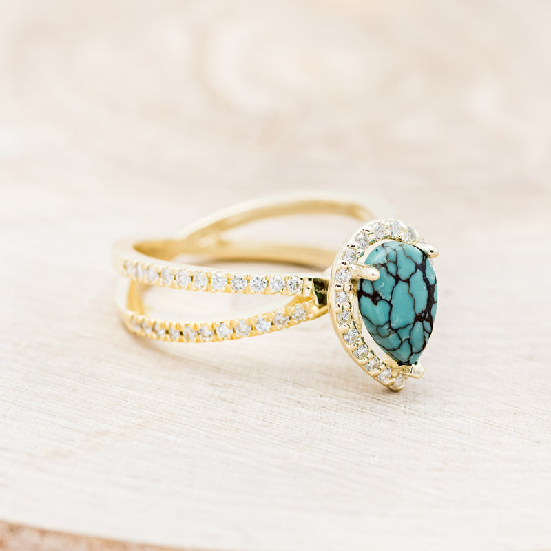 Shown here is "Nala", a split shank-style turquoise women's engagement ring with a diamond halo and diamond accents, facing right. Many other center stone options are available upon request.