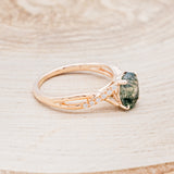 Shown here is "Roslyn", an oval moss agate women's engagement ring with diamond accents, facing right. Many other center stone options are available upon request.