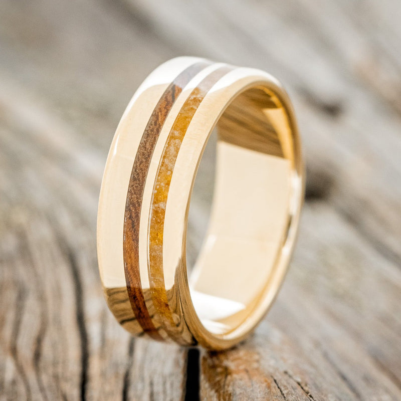 Shown here is "Cosmo", a custom, handcrafted men's wedding ring featuring two offset inlays with amber and ironwood inlays, upright facing left. Additional inlay options are available upon request.