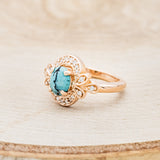 Shown here is "Nora", a vintage-style turquoise women's engagement ring with diamond accents, facing left. Many other center stone options are available upon request.