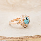 Shown here is "Nora", a vintage-style turquoise women's engagement ring with diamond accents, facing right. Many other center stone options are available upon request.