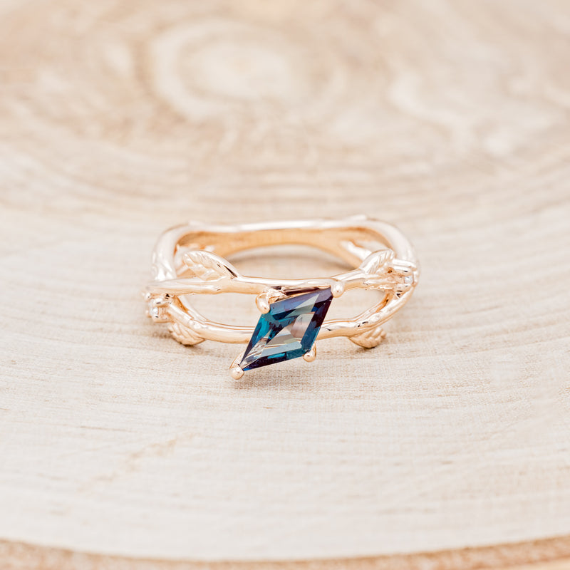 Shown here is "Artemis on the Vine", a branch-style lab-created alexandrite women's engagement ring with diamond and leaf accents, front facing. Many other center stone options are available upon request.